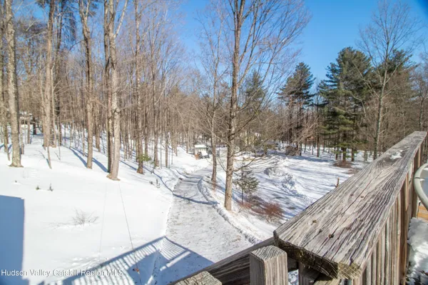 a view of a backyard with wooden fence