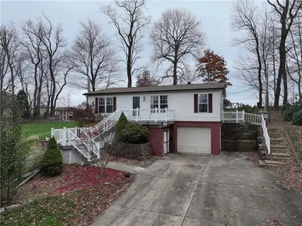 a view of a house with backyard and sitting area