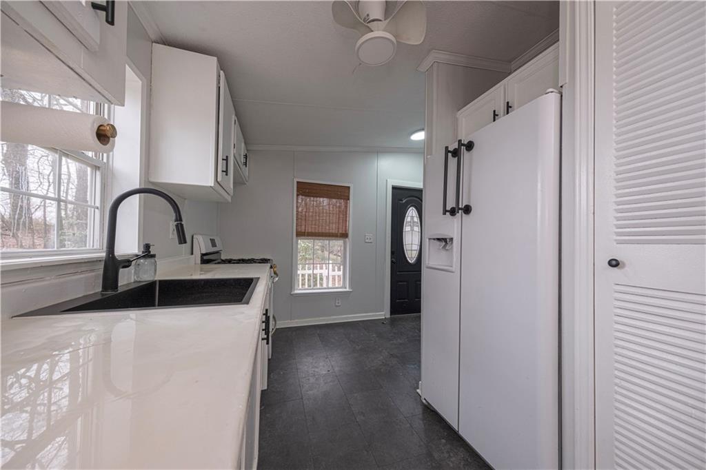 111 Leopard Road Evans City, PA 16033 - Photo 13 of 43 a kitchen with a refrigerator and a sink