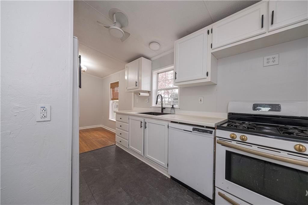 111 Leopard Road Evans City, PA 16033 - Photo 15 of 43 a kitchen with stainless steel appliances granite countertop a stove a sink and white cabinets
