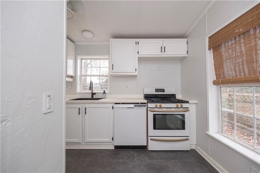 111 Leopard Road Evans City, PA 16033 - Photo 16 of 43 a kitchen with cabinets appliances and a window