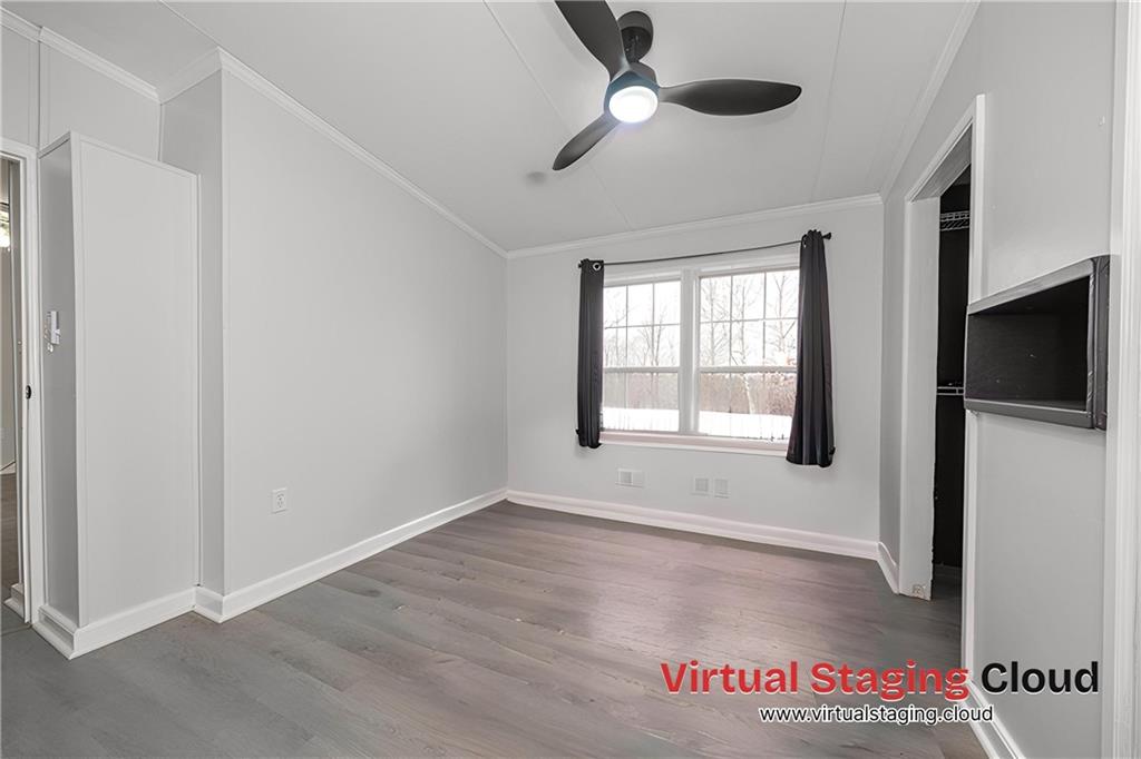 111 Leopard Road Evans City, PA 16033 - Photo 20 of 43 a view of an empty room with a window and wooden floor