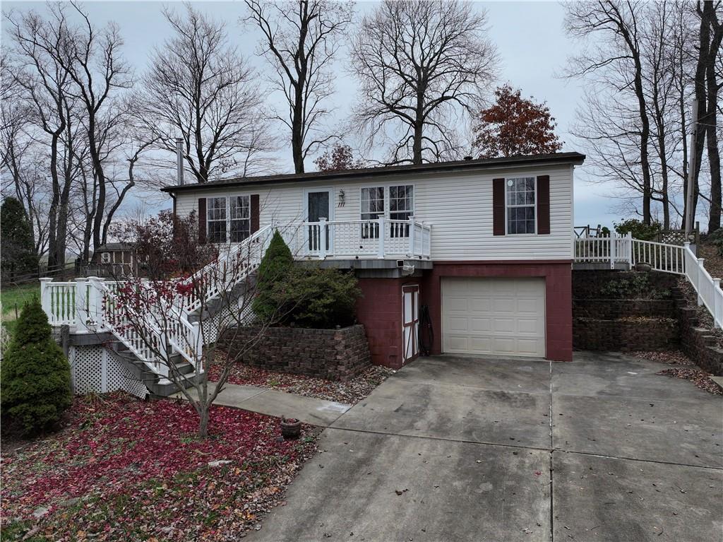 111 Leopard Road Evans City, PA 16033 - Photo 2 of 43 a front view of a house with a yard and garage