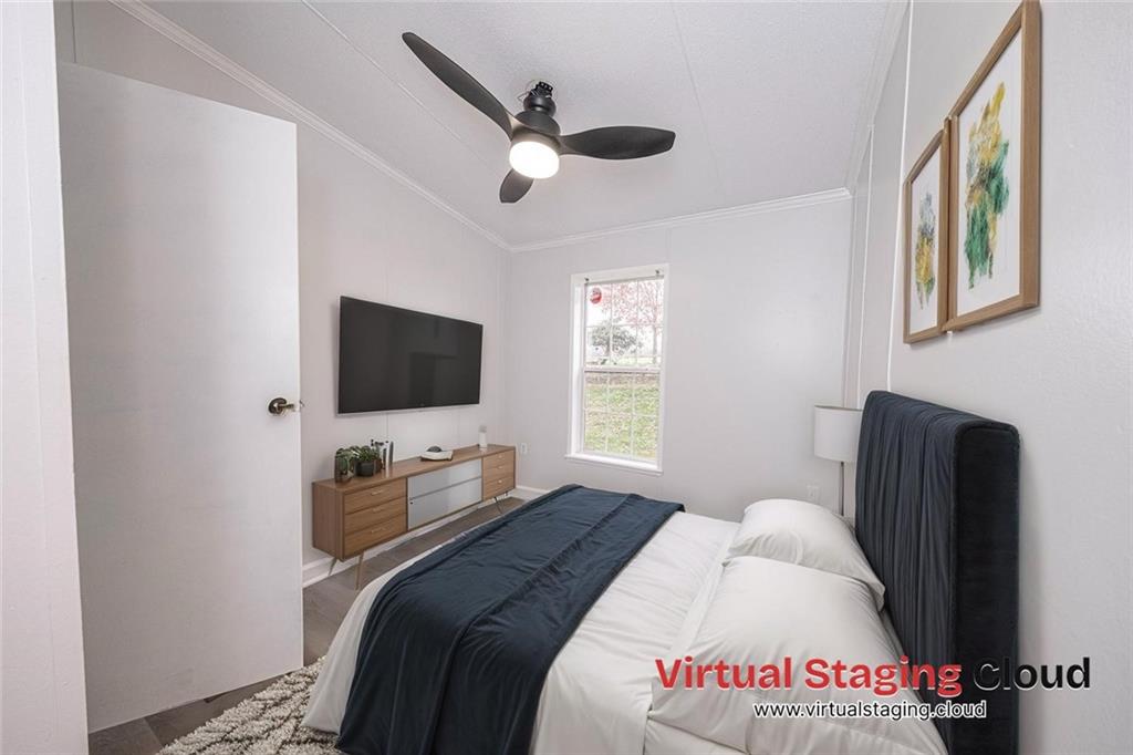 111 Leopard Road Evans City, PA 16033 - Photo 22 of 43 a bedroom with a bed and a flat screen tv