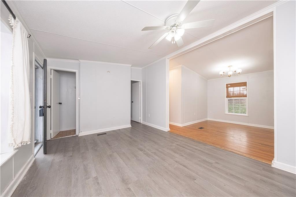 111 Leopard Road Evans City, PA 16033 - Photo 6 of 43 a view of an empty room with window and wooden floor