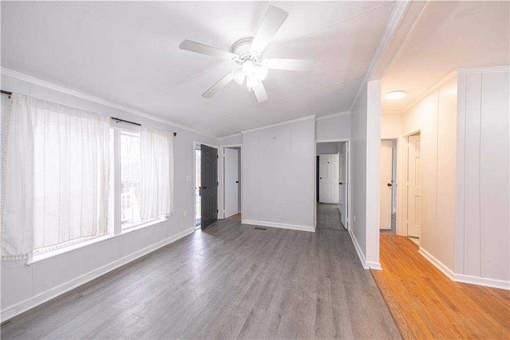 111 Leopard Road Evans City, PA 16033 - Photo 9 of 43 a view of an empty room with wooden floor and a window
