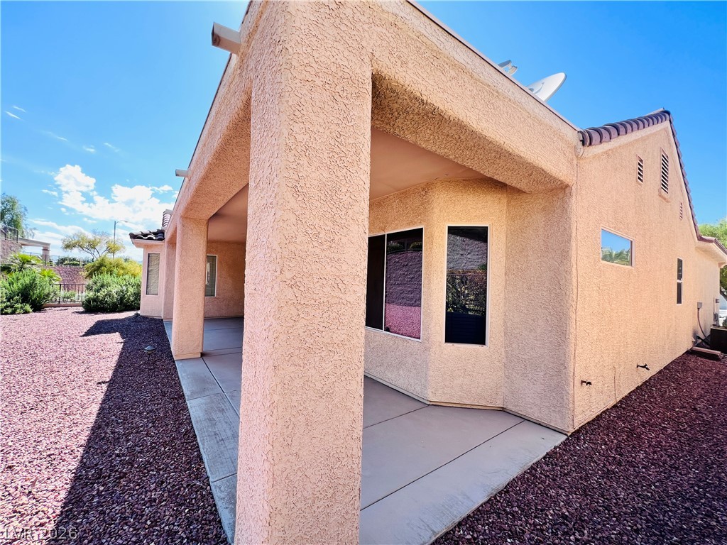 3047 Hickory Valley Road Henderson, NV 89052 - Photo 28 of 33 A private covered patio extends across the back of this desert-landscaped residence.