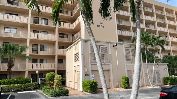 a front view of a multi story building with a yard