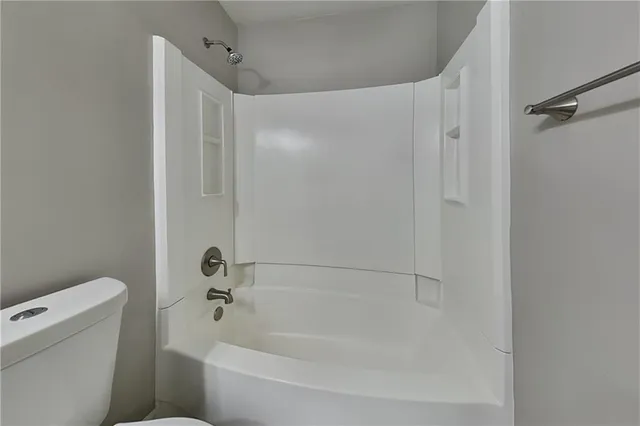 a bathroom with a bathtub and a toilet
