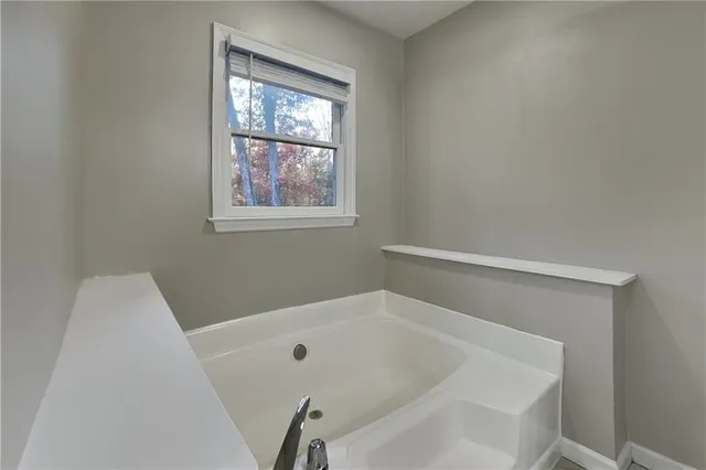 a white bath tub sitting in a bathroom