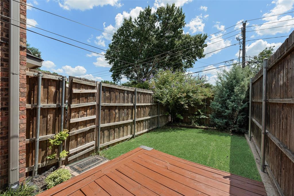 4988 Thunder Road Dallas, TX 75244 - Photo 31 of 32 Private backyard featuring a wood deck, manicured lawn, and surrounding privacy fencing