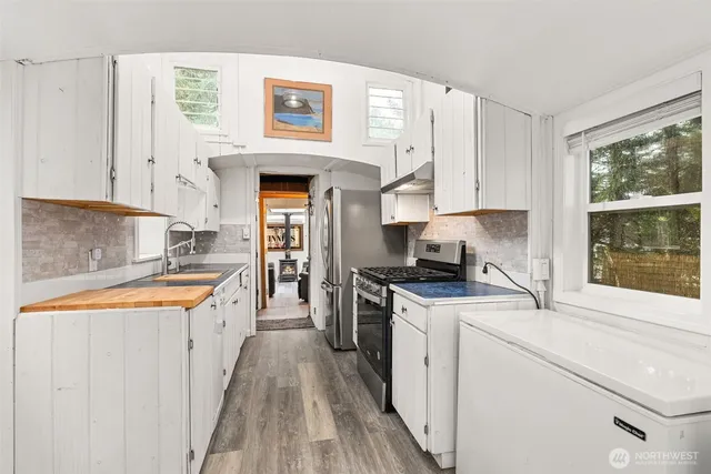 an entryway with a mirror and a window