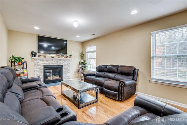 a living room with furniture a flat screen tv and a fireplace
