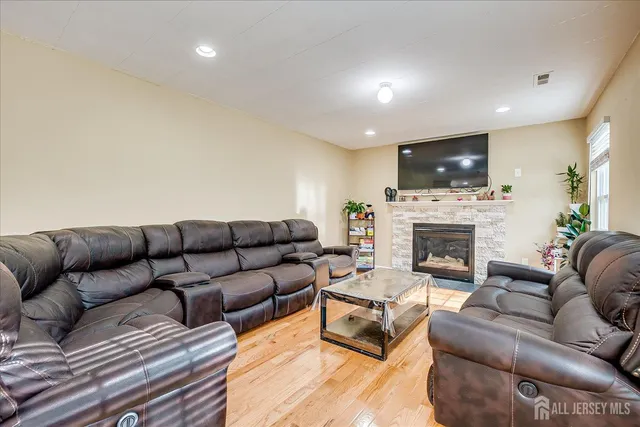 a living room with furniture a fireplace and a flat screen tv