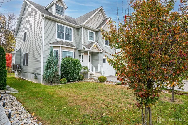 a front view of a house with yard and green space