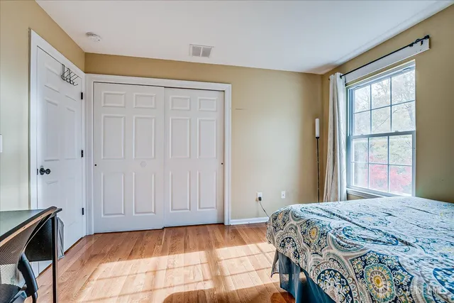 a bedroom with a bed and a window