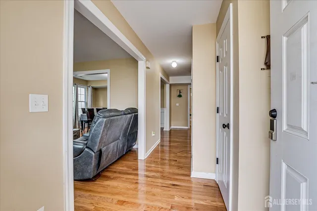 a view of a hallway with a livingroom and furniture