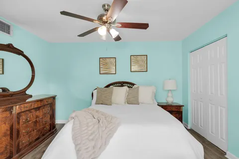 a bedroom with a large bed and a chandelier