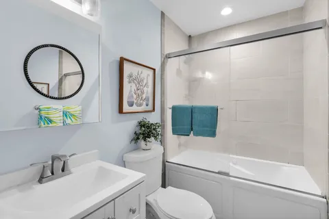 a bathroom with a sink toilet and a mirror