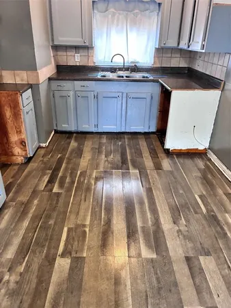 a kitchen with wooden cabinets and sink