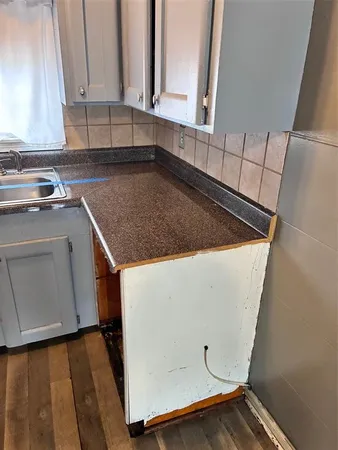 a view of a kitchen with sink and cabinets