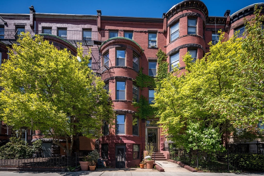 a front view of a building with garden