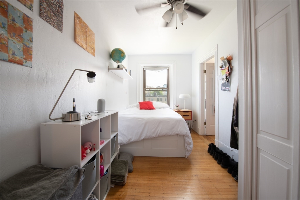 918 Beacon Street, Unit 3 Boston, MA 02215 - Photo 11 of 19 a bed room with a bed and a chandelier