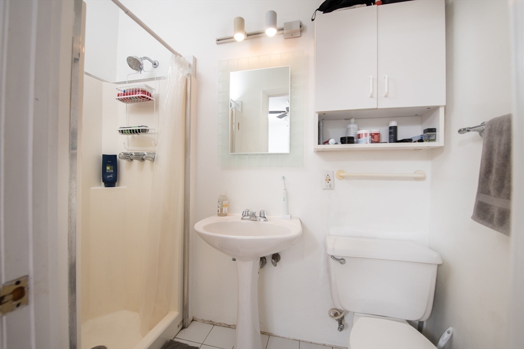 918 Beacon Street, Unit 3 Boston, MA 02215 - Photo 13 of 19 a bathroom with a sink toilet and a mirror