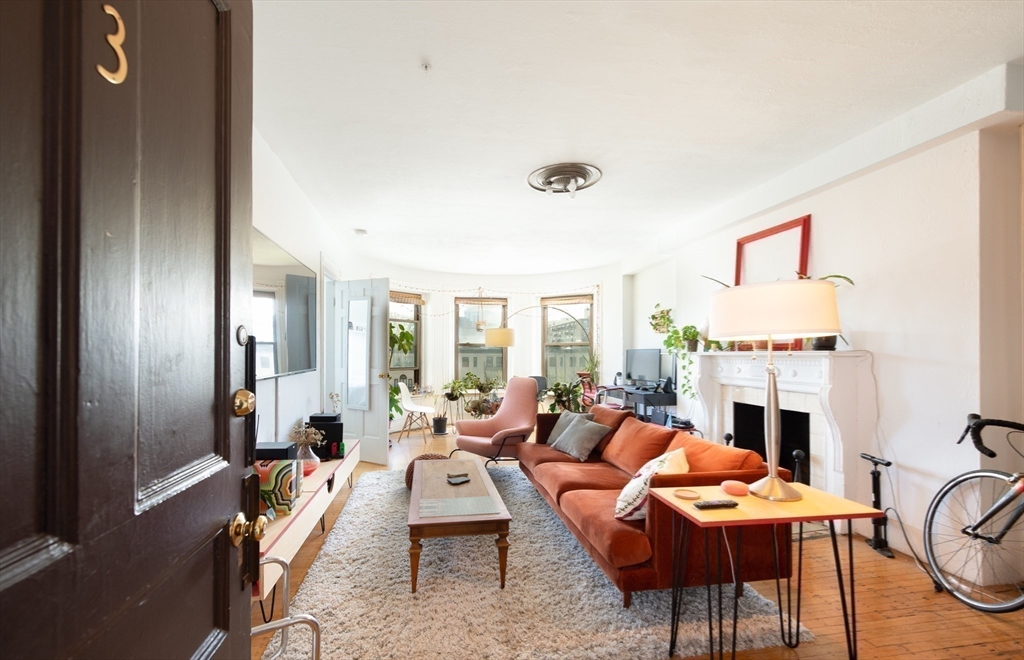 918 Beacon Street, Unit 3 Boston, MA 02215 - Photo 14 of 19 a living room with furniture a fireplace and a table