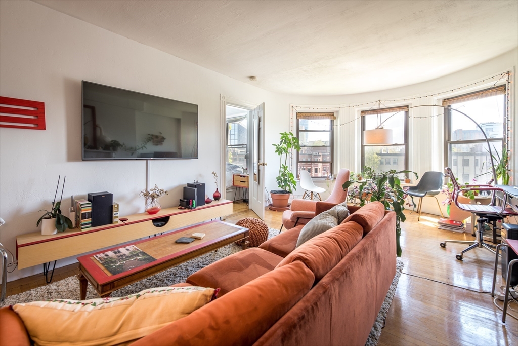 918 Beacon Street, Unit 3 Boston, MA 02215 - Photo 2 of 19 a bedroom with furniture and a flat screen tv