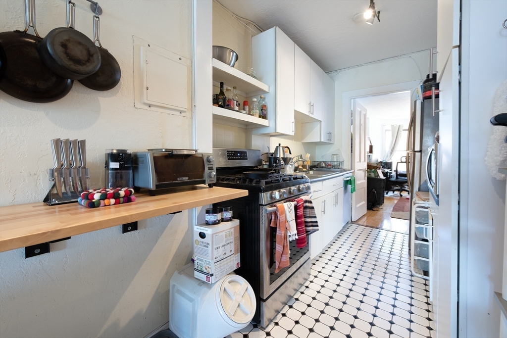 918 Beacon Street, Unit 3 Boston, MA 02215 - Photo 6 of 19 a kitchen with a sink and cabinets