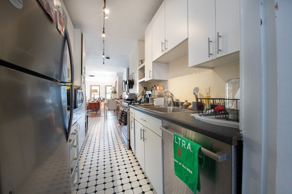 918 Beacon Street, Unit 3 Boston, MA 02215 - Photo 7 of 19 a kitchen with stainless steel appliances granite countertop a sink and cabinets