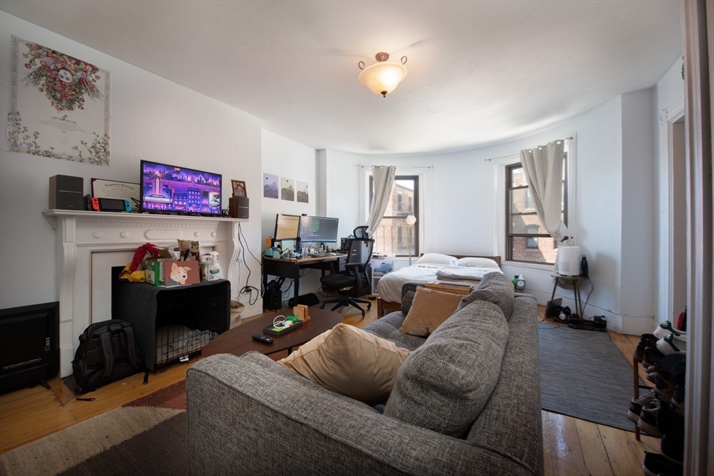 918 Beacon Street, Unit 3 Boston, MA 02215 - Photo 9 of 19 a living room with furniture and a fireplace