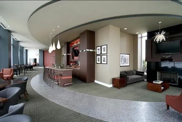 a living room with furniture a flat screen tv and a table