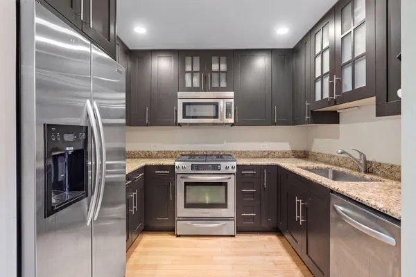 a kitchen with a stove sink and refrigerator