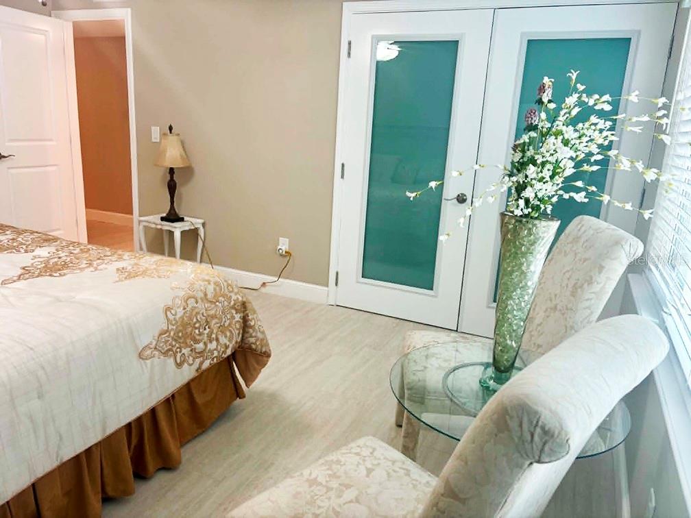 4455 Duhme Road, Unit 103 St. Petersburg, FL 33708 - Photo 16 of 37 a bedroom with a bed and a mirror