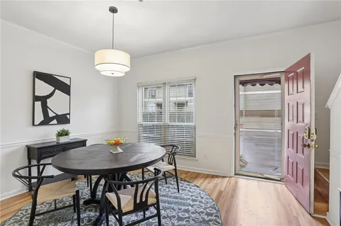 a view of a dining room with furniture wooden floor and a chandelier