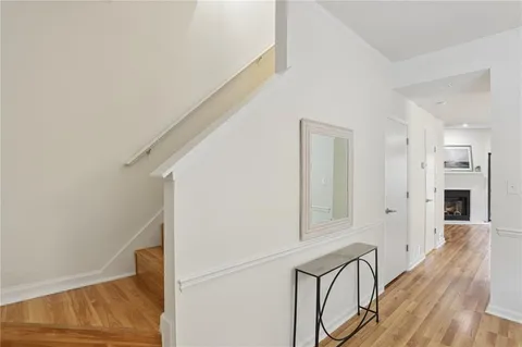 a view of a hallway with wooden floor and staircase