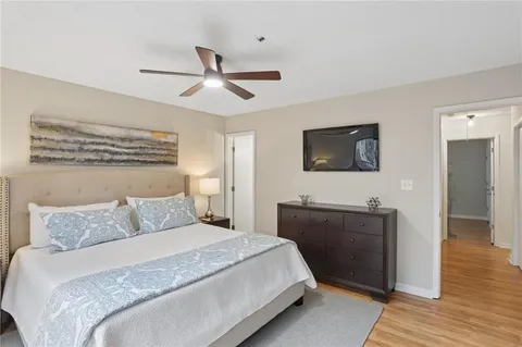 a bedroom with a bed and a flat screen tv