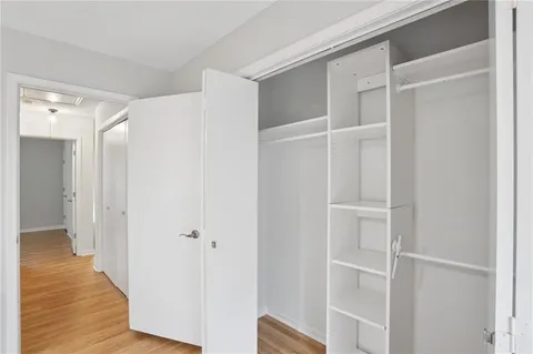 a view of closet area with wooden floor
