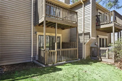 a view of a house with a yard and deck