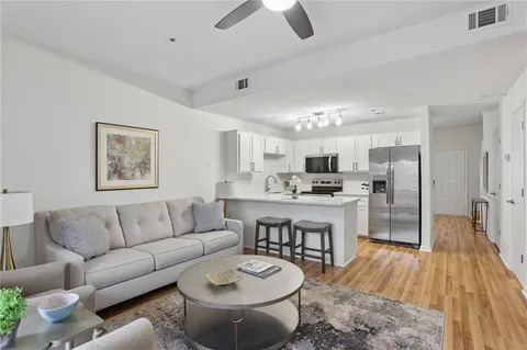 a living room with furniture and a wooden floor