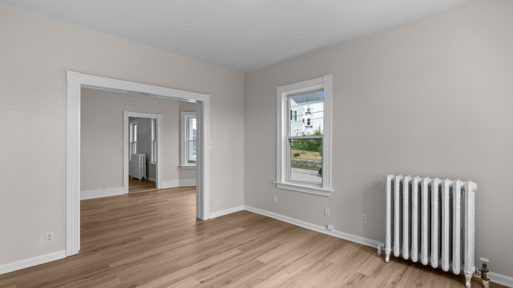 835-837 Stafford Road Fall River, MA 02721 - Photo 8 of 41 an empty room with wooden floor and a window