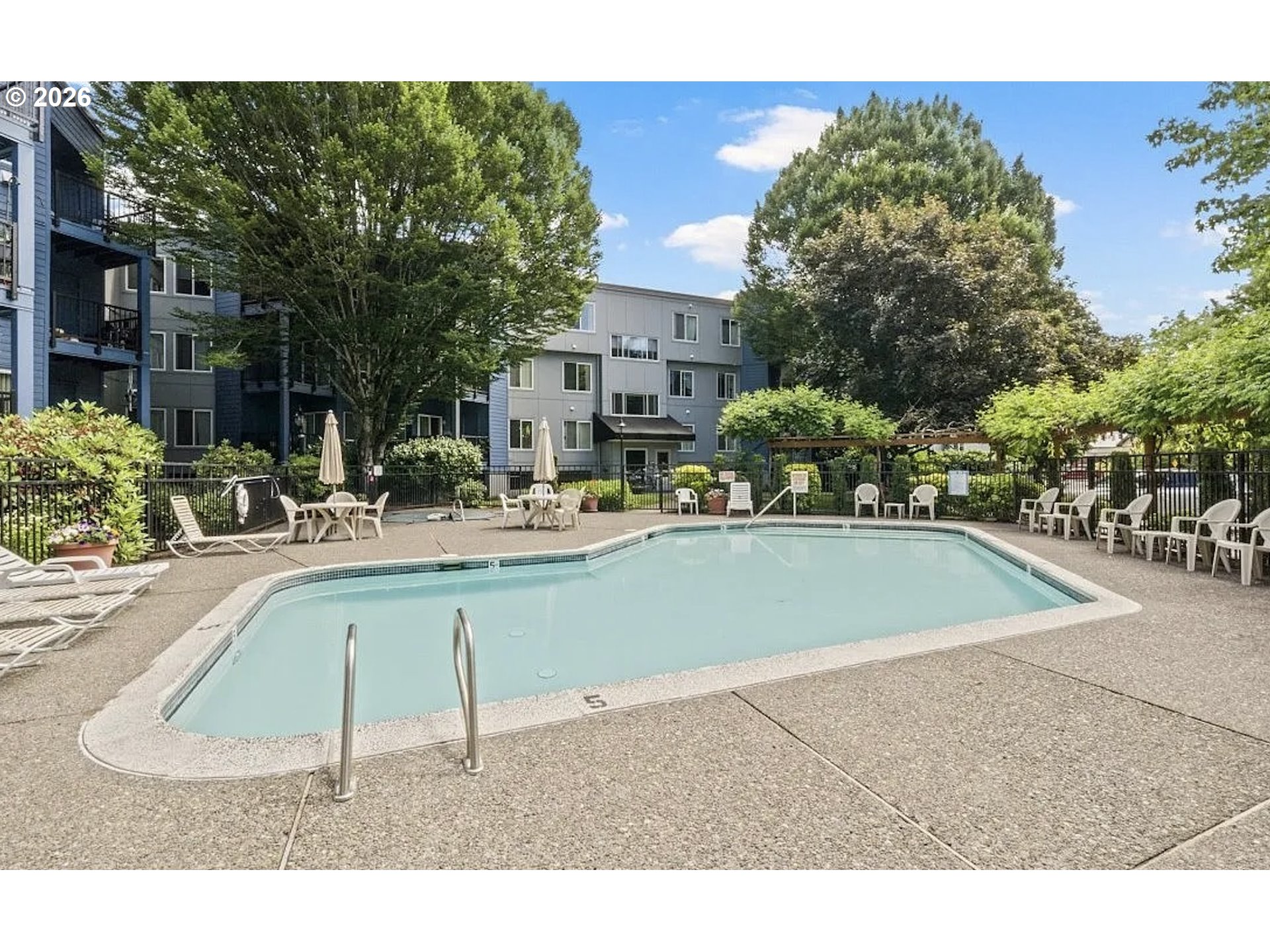 8720 Southwest Tualatin Road, Unit 205 Tualatin, OR 97062 - Photo 2 of 23 a swimming pool with outdoor seating and yard