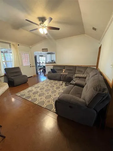 a living room with furniture and a chandelier