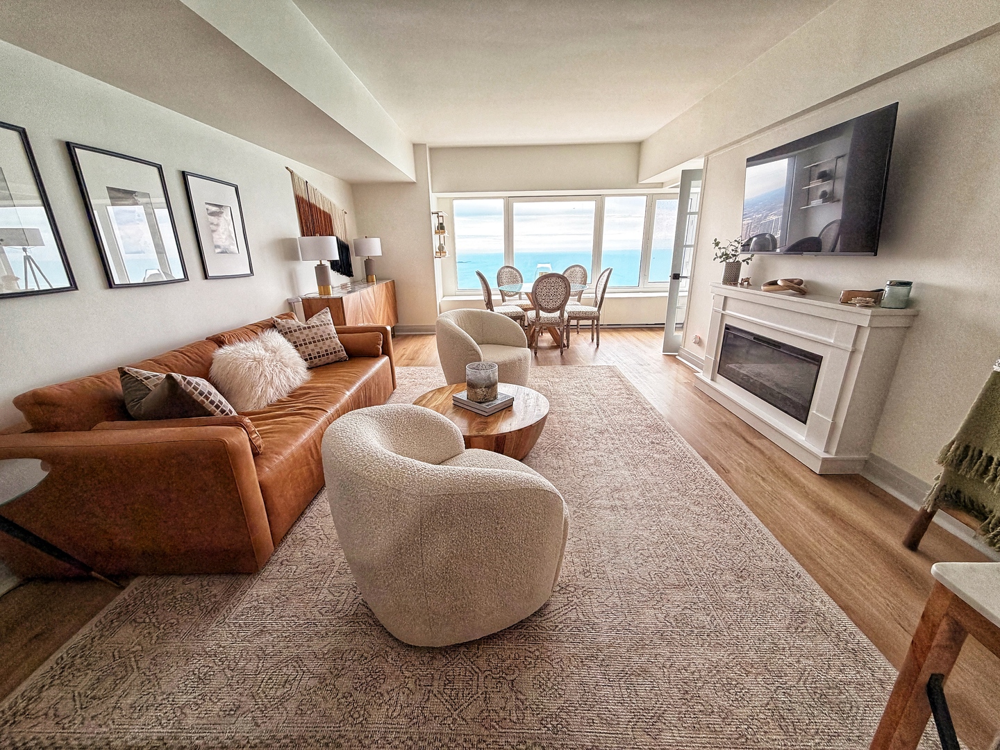 175 East Delaware Place, Unit 5808 Chicago, IL 60611 - Photo 6 of 29 a living room with furniture a flat screen tv and a fireplace