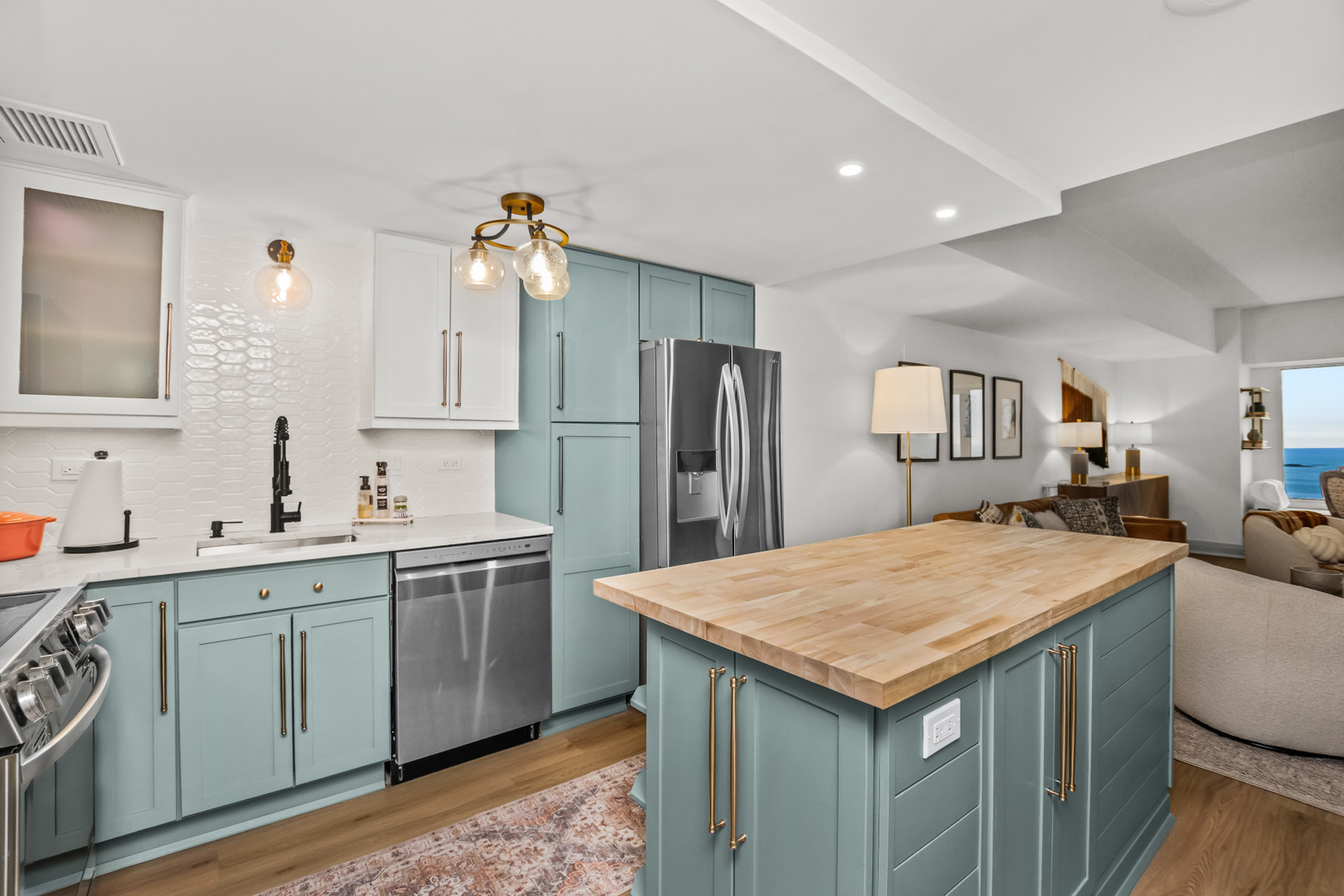 175 East Delaware Place, Unit 5808 Chicago, IL 60611 - Photo 9 of 29 a kitchen with a sink refrigerator and cabinets