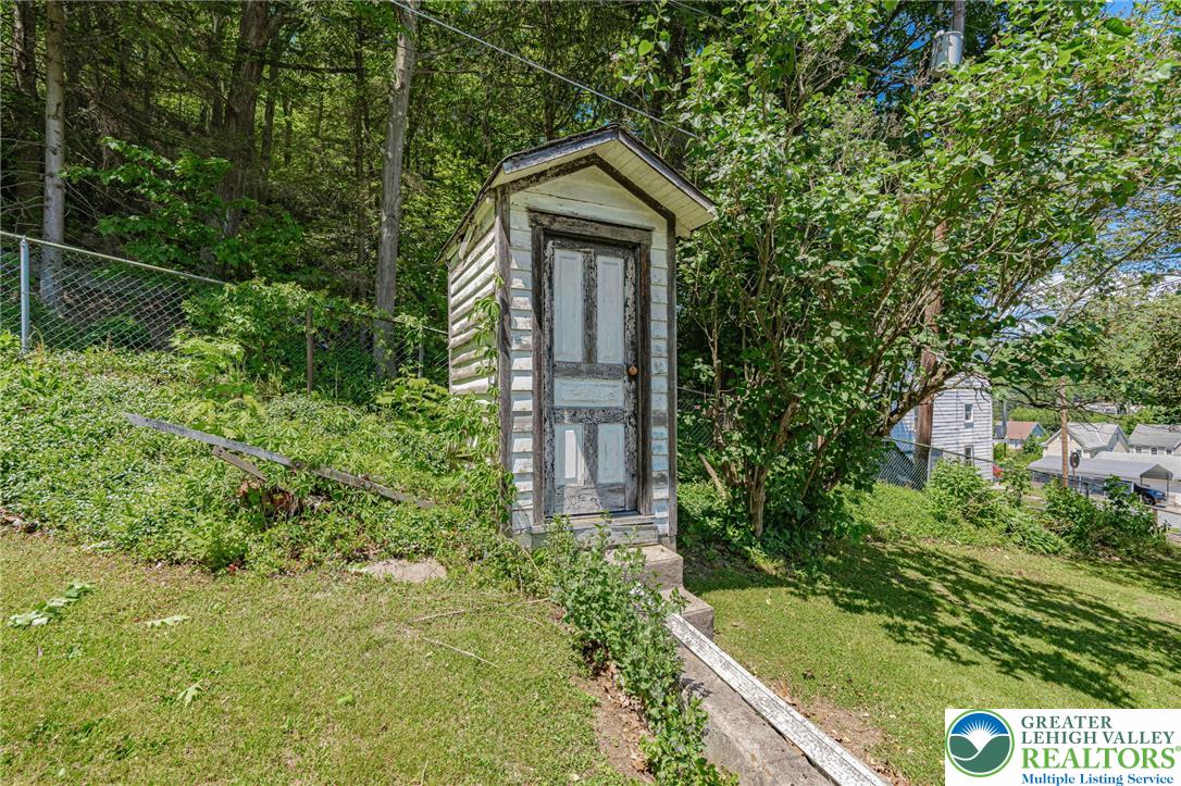 159 West Ridge Street Nesquehoning, PA 18240 - Photo 39 of 55 A charming outbuilding stands amidst lush greenery, offering a rustic appeal.