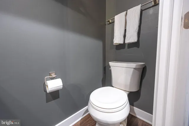 a white toilet sitting next to a shower curtain