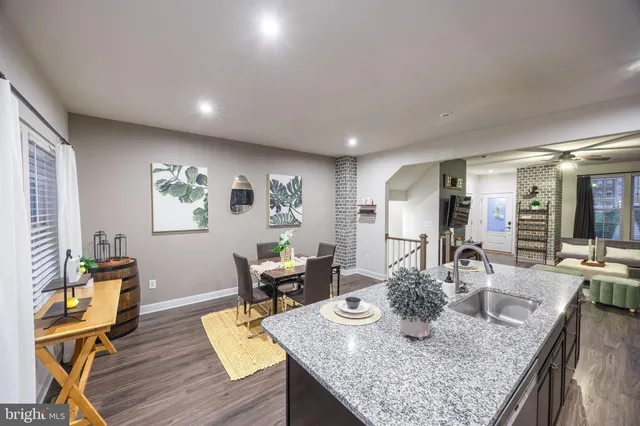 a dining room with furniture and wooden floor